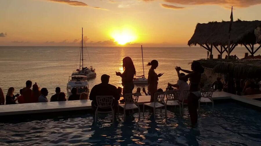 From Montego Bay: Negril Beach & Rick's Cafe Sunset Day Trip - Margaritaville for food, drinks, and easy entertainment