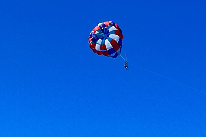 Parasailing above Turquoise Ocean Waters in Montego Bay - After landing, use the beach time